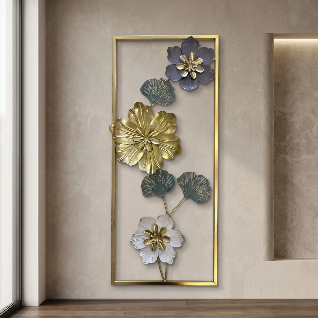 Tall metal wall art with blue gold and white cascading flowers in a gold frame