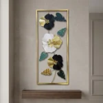 Tall metal wall art with navy white and black ribbed flowers and teal leaves in a gold frame