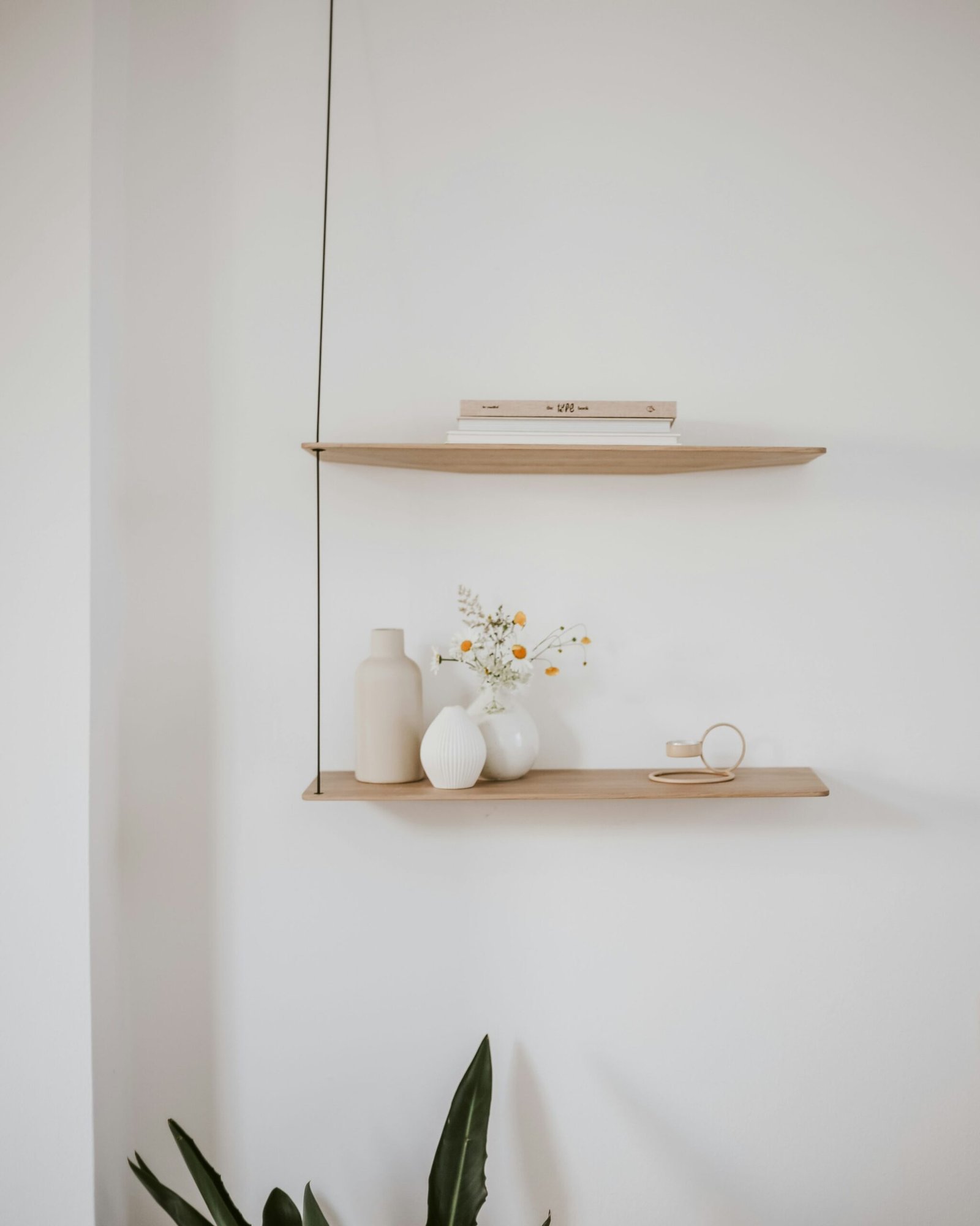 Minimal wooden shelves styled with vases flowers and home decor